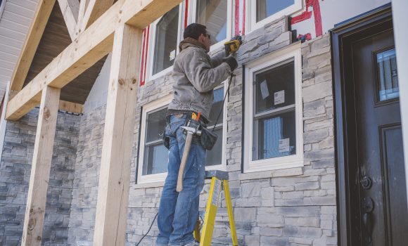 Builder tiling facade of house